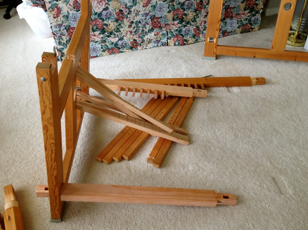 New pieces for 70cm loom being added: treadle beam at the back, foot rest at the front, and upper and lower lamms in the middle. No need to replace the treadles, on the floor by the old 100cm treadle beam.