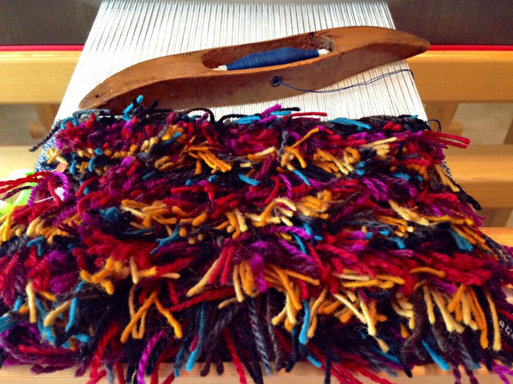 Rya knots, an assortment of colors in wool yarn.