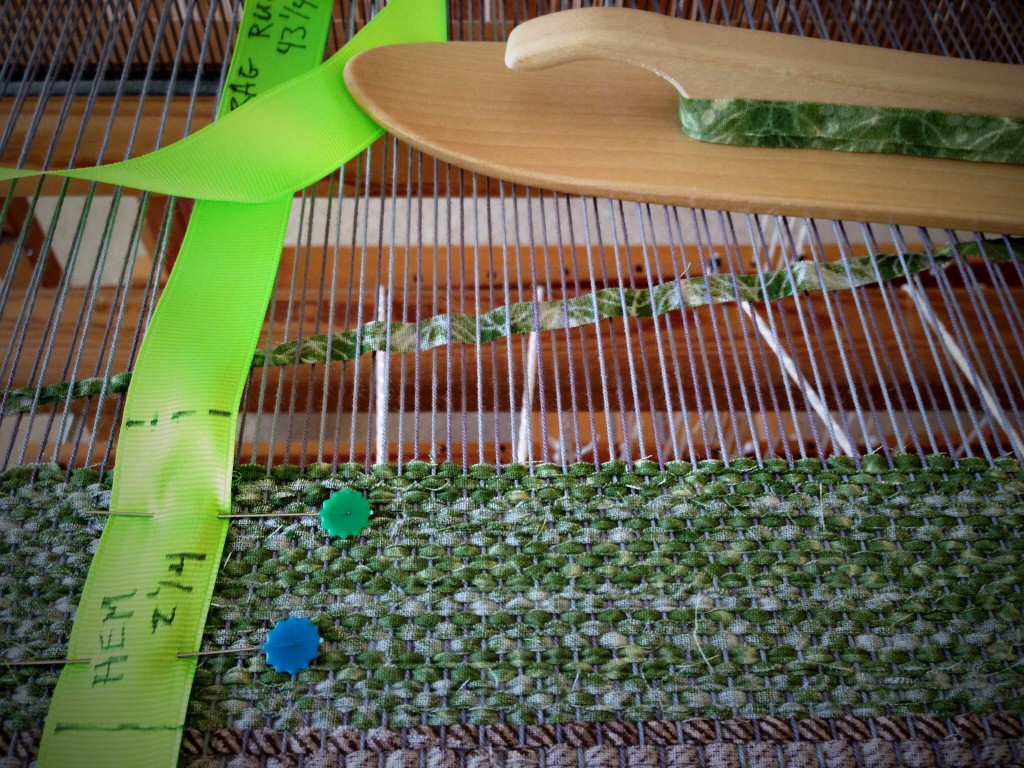 Weaving narrow strips for rag rug hem.