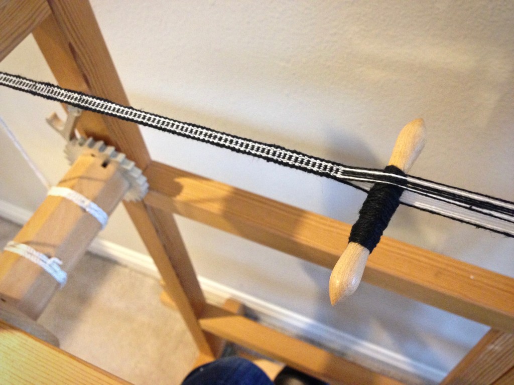 Simple narrow band for hanging tabs on handwoven towels.