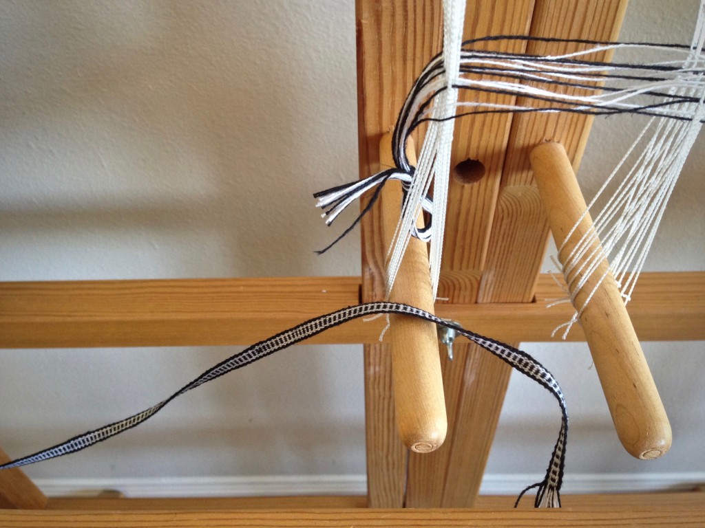 Woven band for hanging tabs on handwoven black and white towels. Karen Isenhower