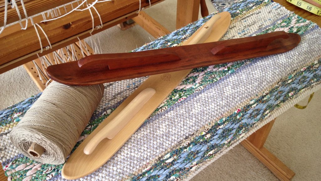 Hand crafted cherry wood ski shuttle, and rosepath rag rug just off the loom.