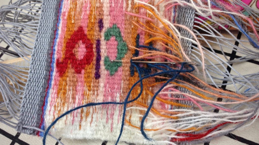 Back of tapestry, sewing in weft tails.