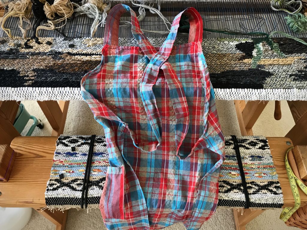 Weaving apron, criss-cross back straps.